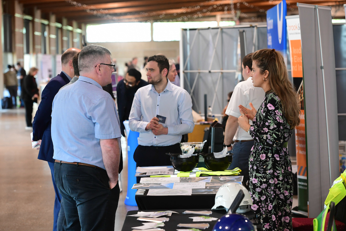 Group of people. Mix of men and women talking at an exhibition